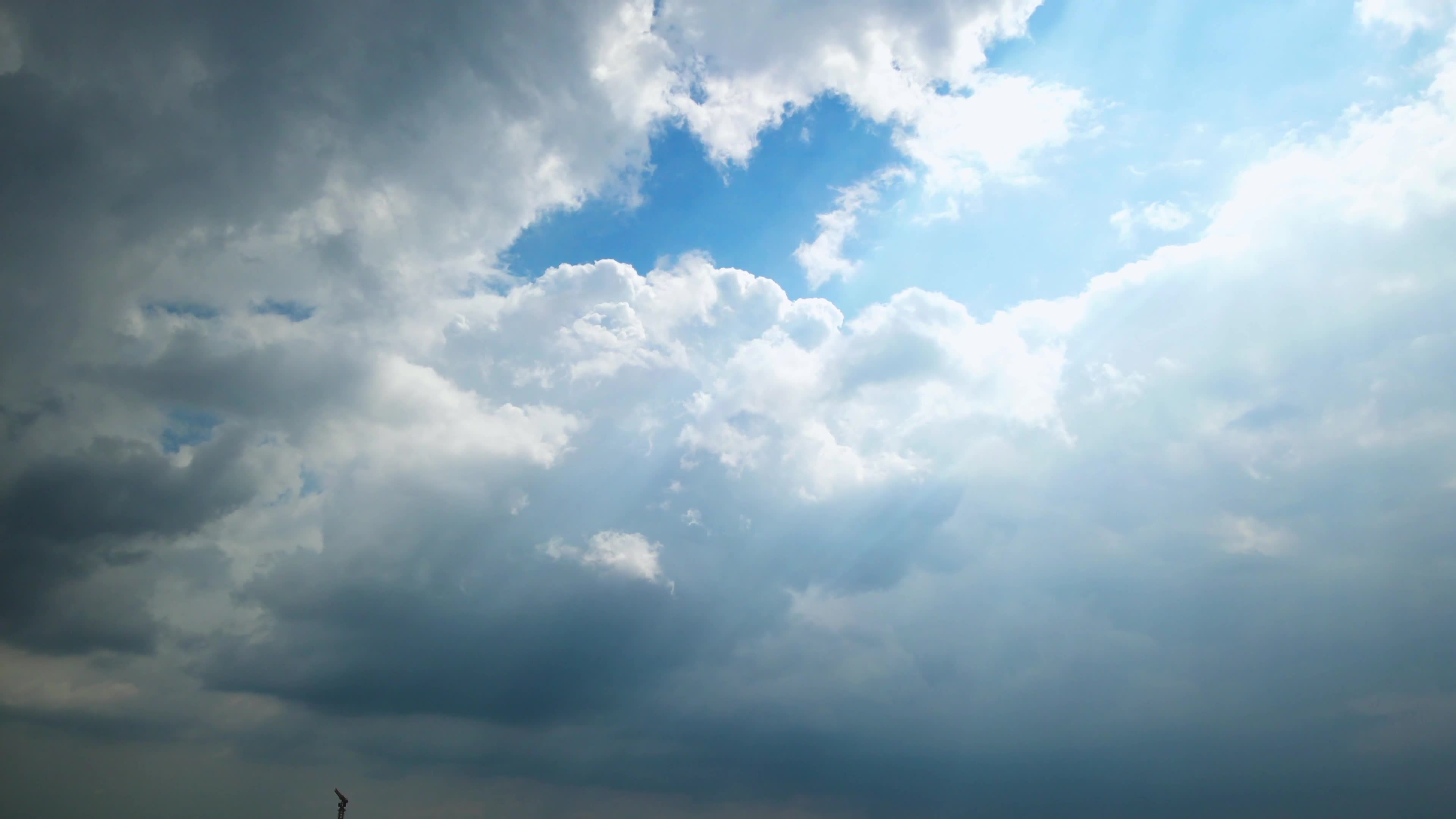 White clouds in the blue sky, light through