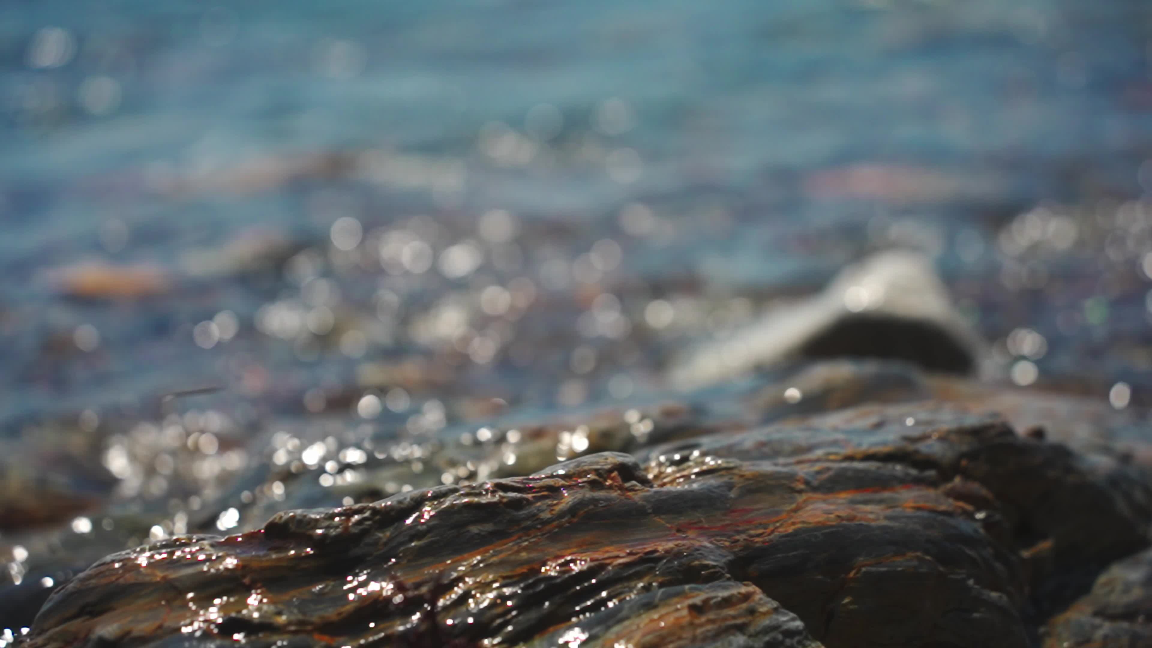 The surface of the sea refracts sunlight to form fuzzy points of light